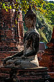 Ayutthaya, Thailand. Wat Mahathat, the Buddha statue of a small vihara with a chedi near the eastern side of the eclosure.